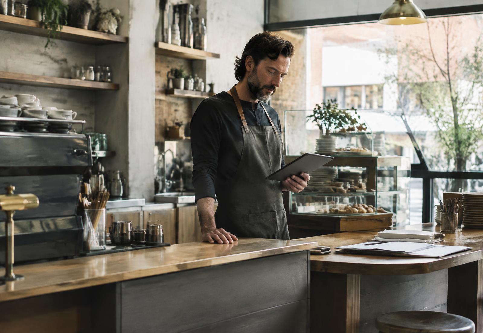 Independent cafe owner at the counter